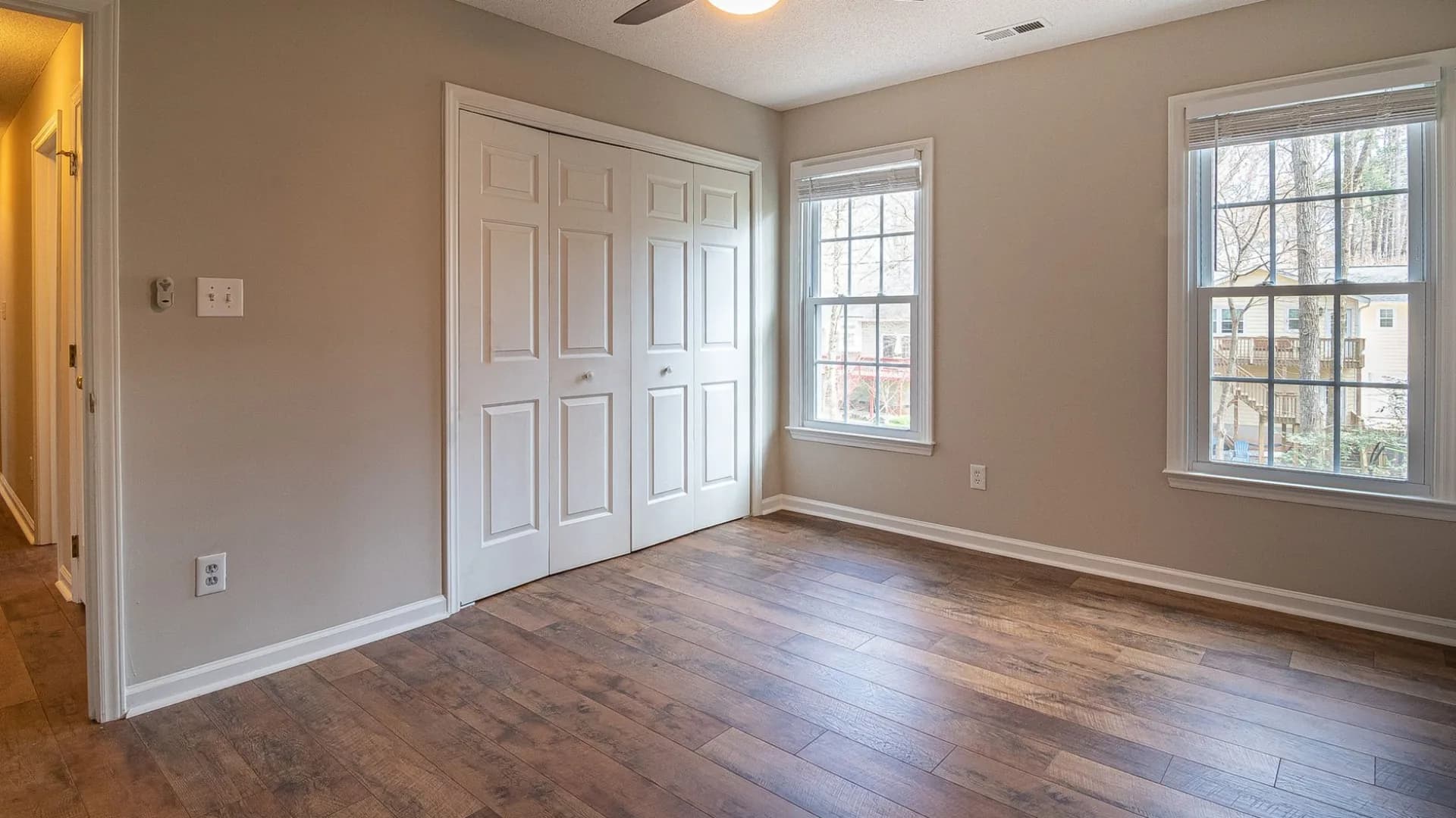 A cleaning professional dusty living room post-renovation.