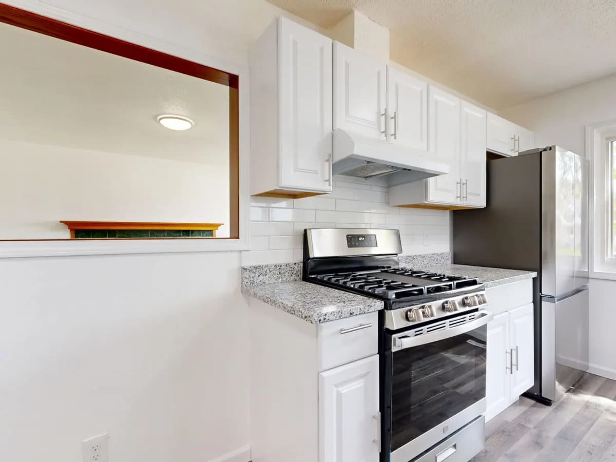 Cleaning professionals in action in a renovated kitchen.