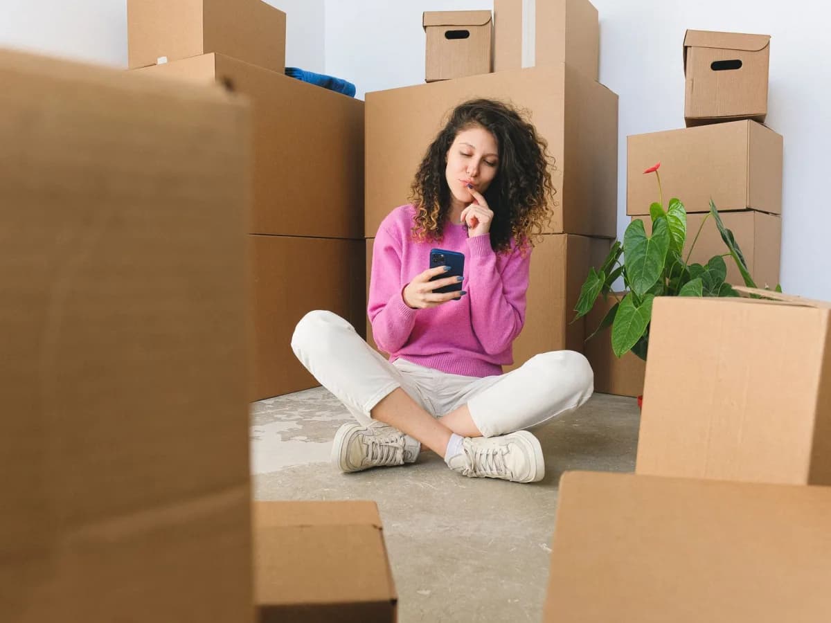Boxes, furniture, and household clutter grouped in a basement for removal