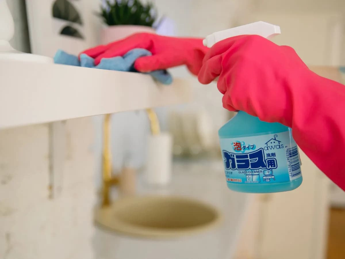 Gloved hands dismantling basement shelving during a cleanout