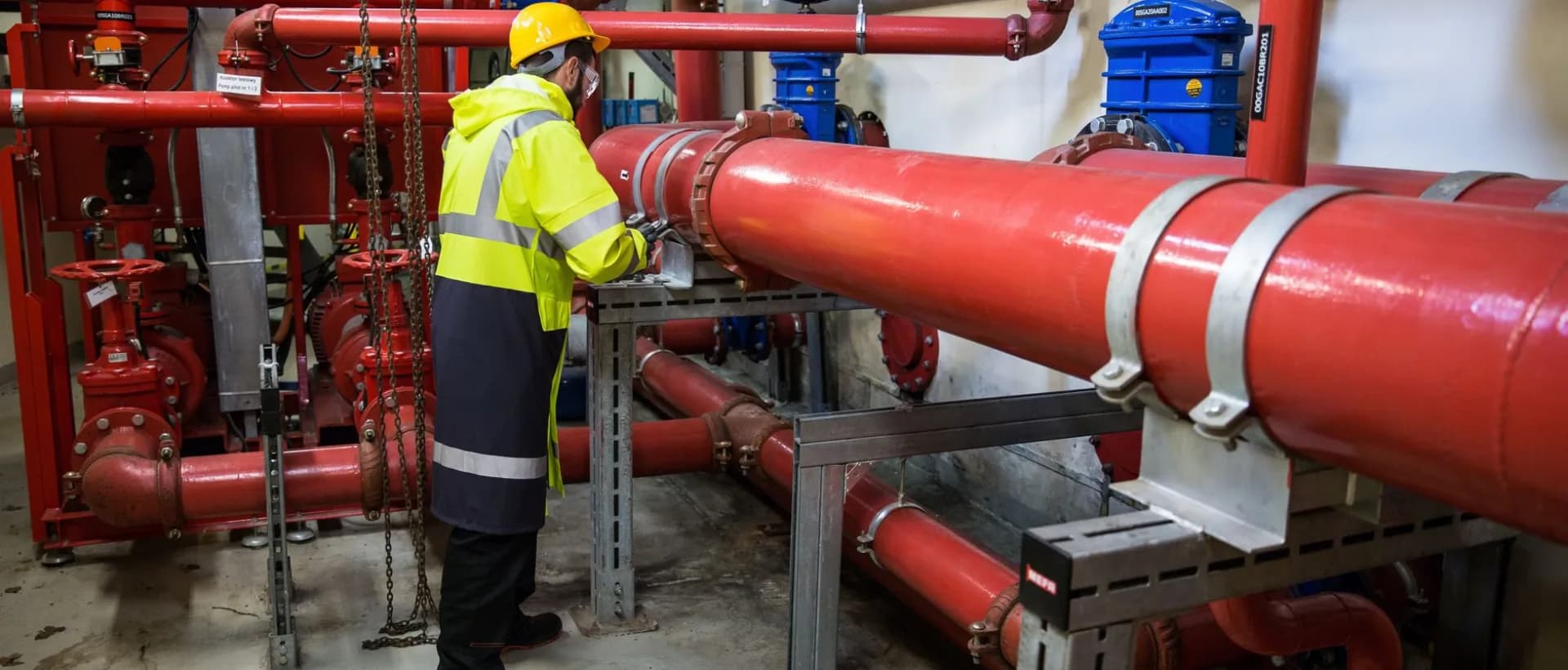 Plumber inspecting a leak under the kitchen sink