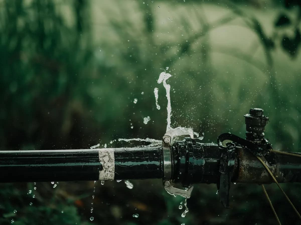 Close-up of a rusted pipe with water damage.
