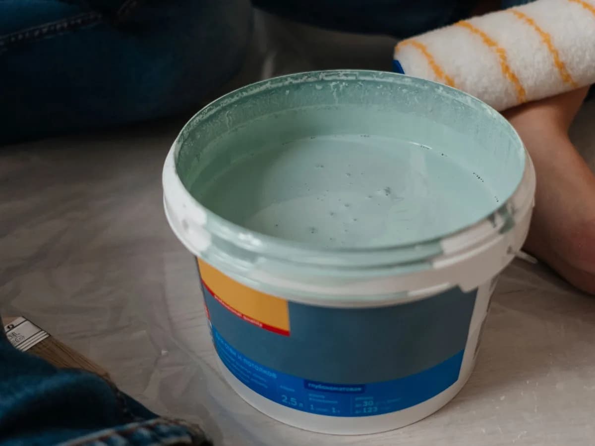 Painting supplies and brush on the floor