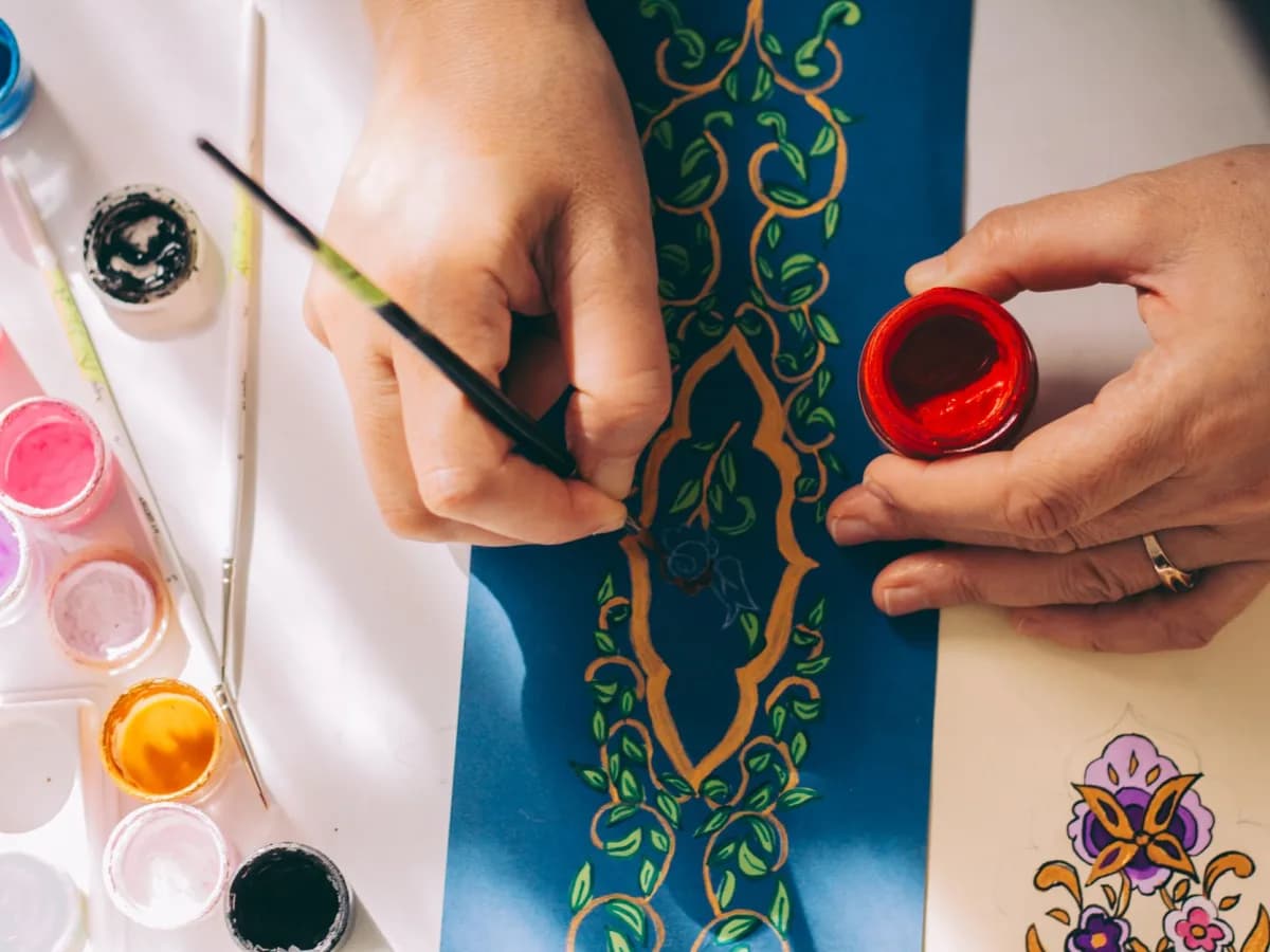 Painter carefully detailing trim work in a home.