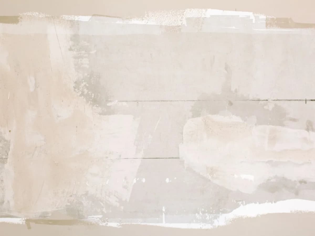 Close-up view of a drywall patch showing smooth finish
