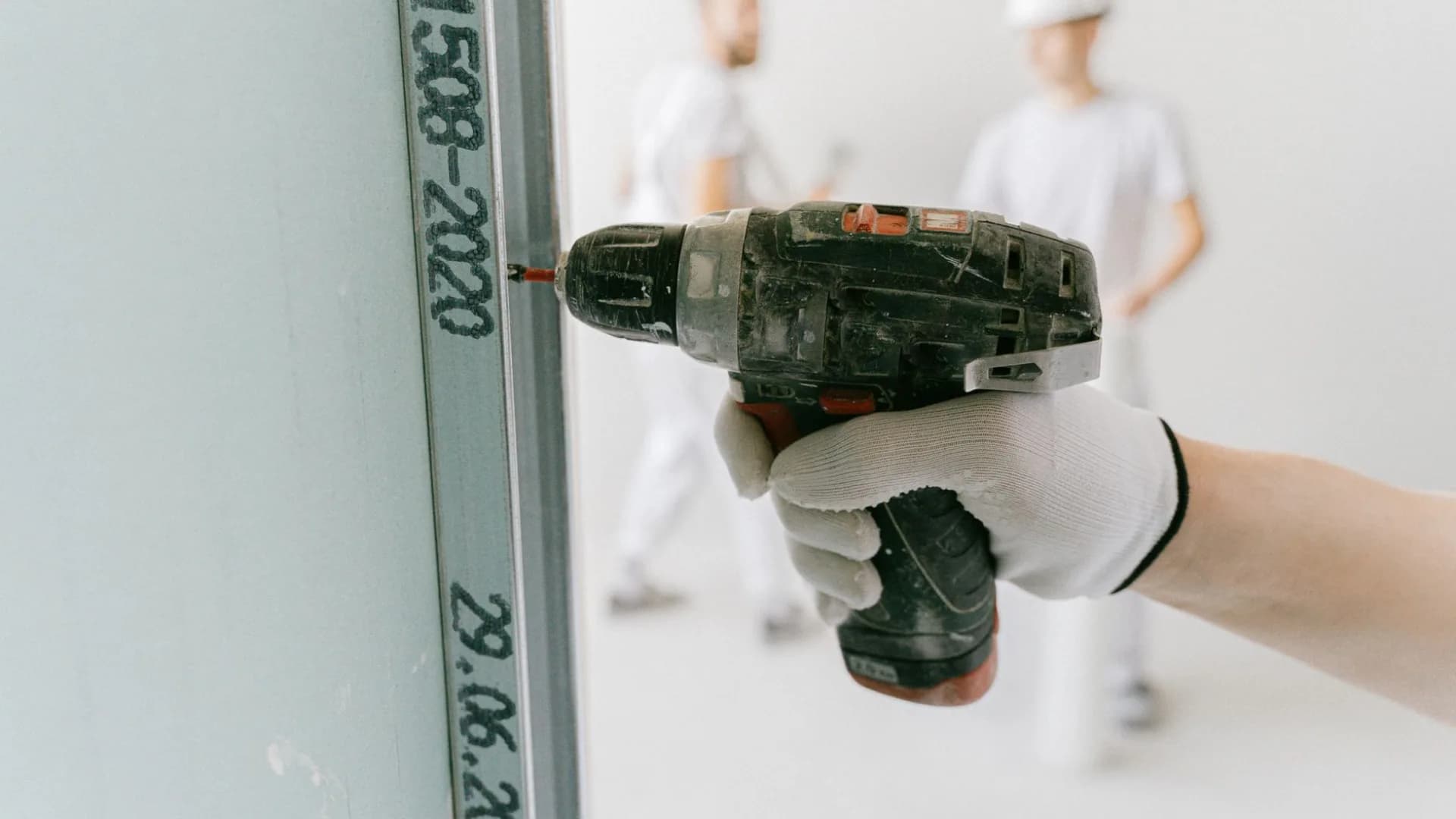 Person repairing drywall in their home