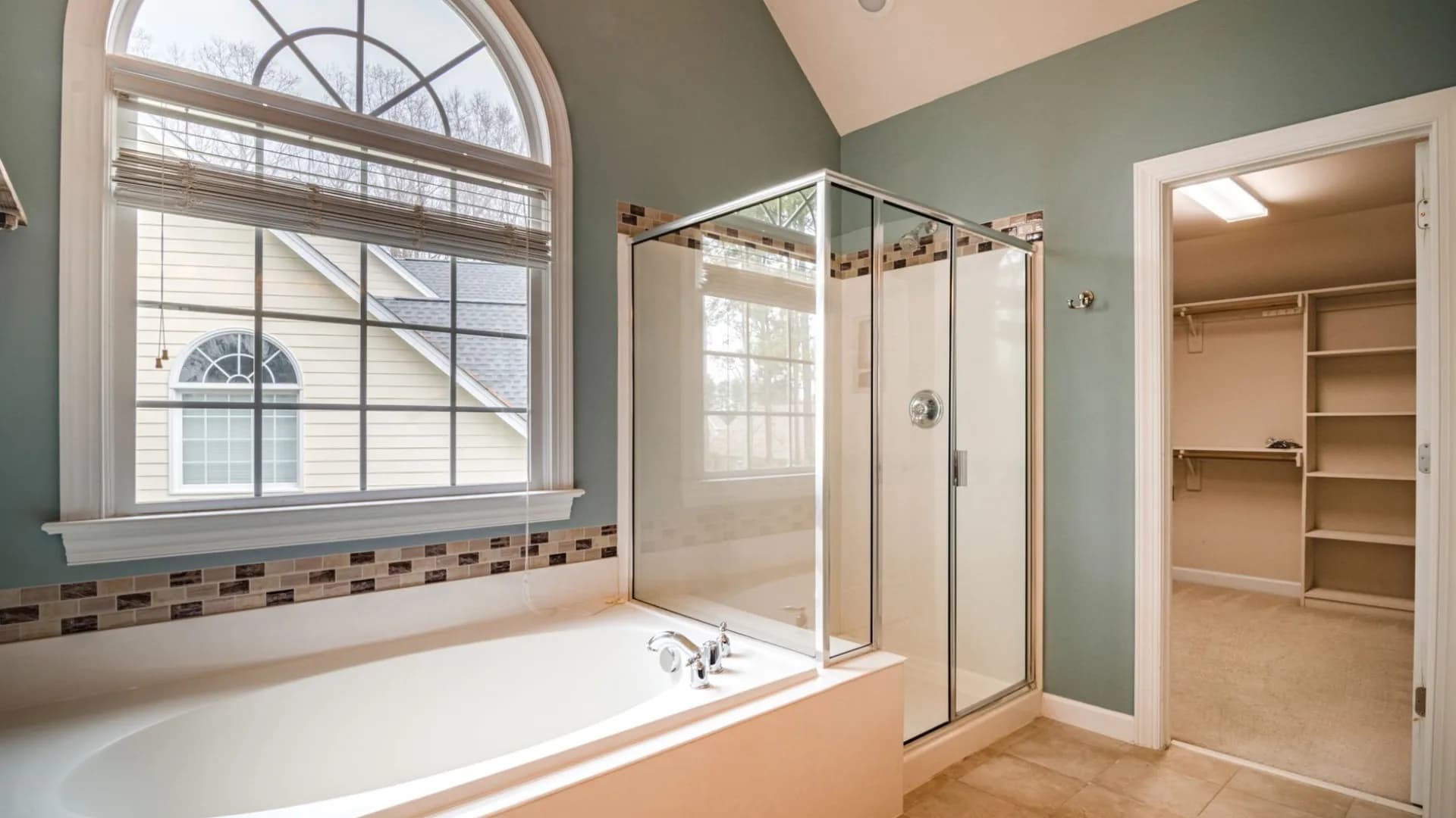 Technician applying caulk around a bathtub