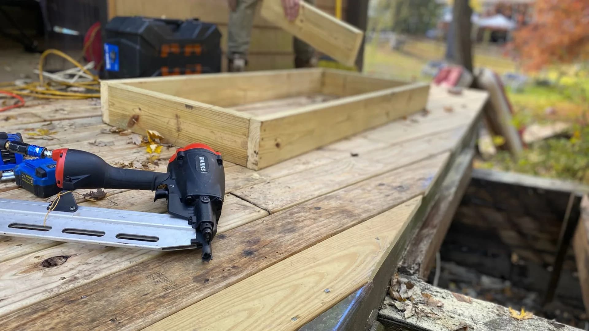 A contractor repairing a residential wooden deck in Toronto.