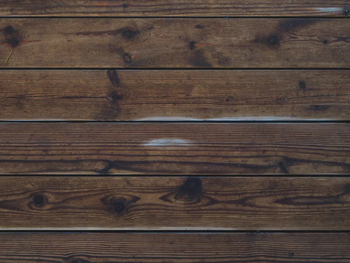 Newly installed deck planks against worn-out wood.