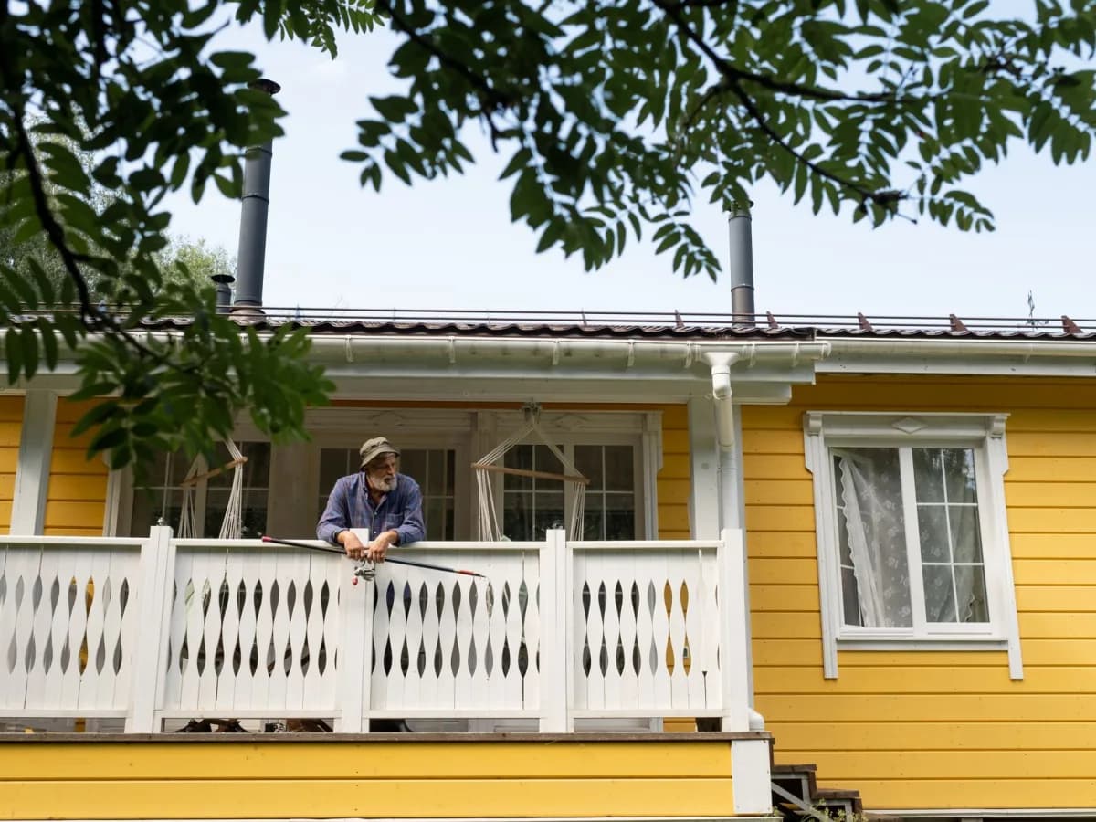 Homeowner inspecting a loose deck railing