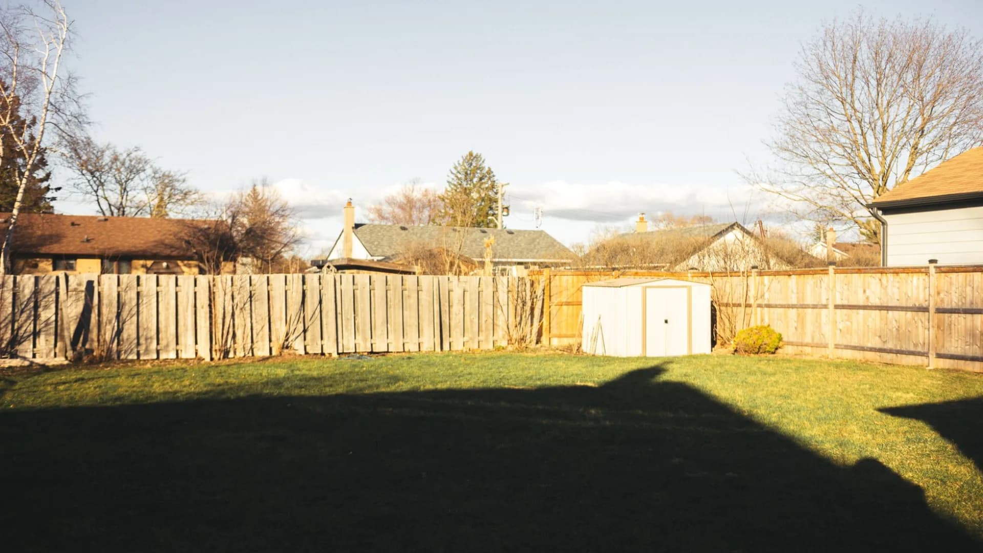 Contractor repairing fence in Toronto backyard