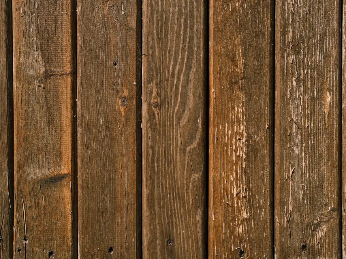 Close-up view of damaged fence panels
