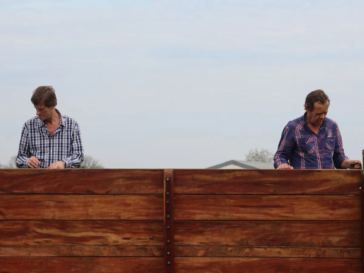 Homeowner conducting a fence stability check