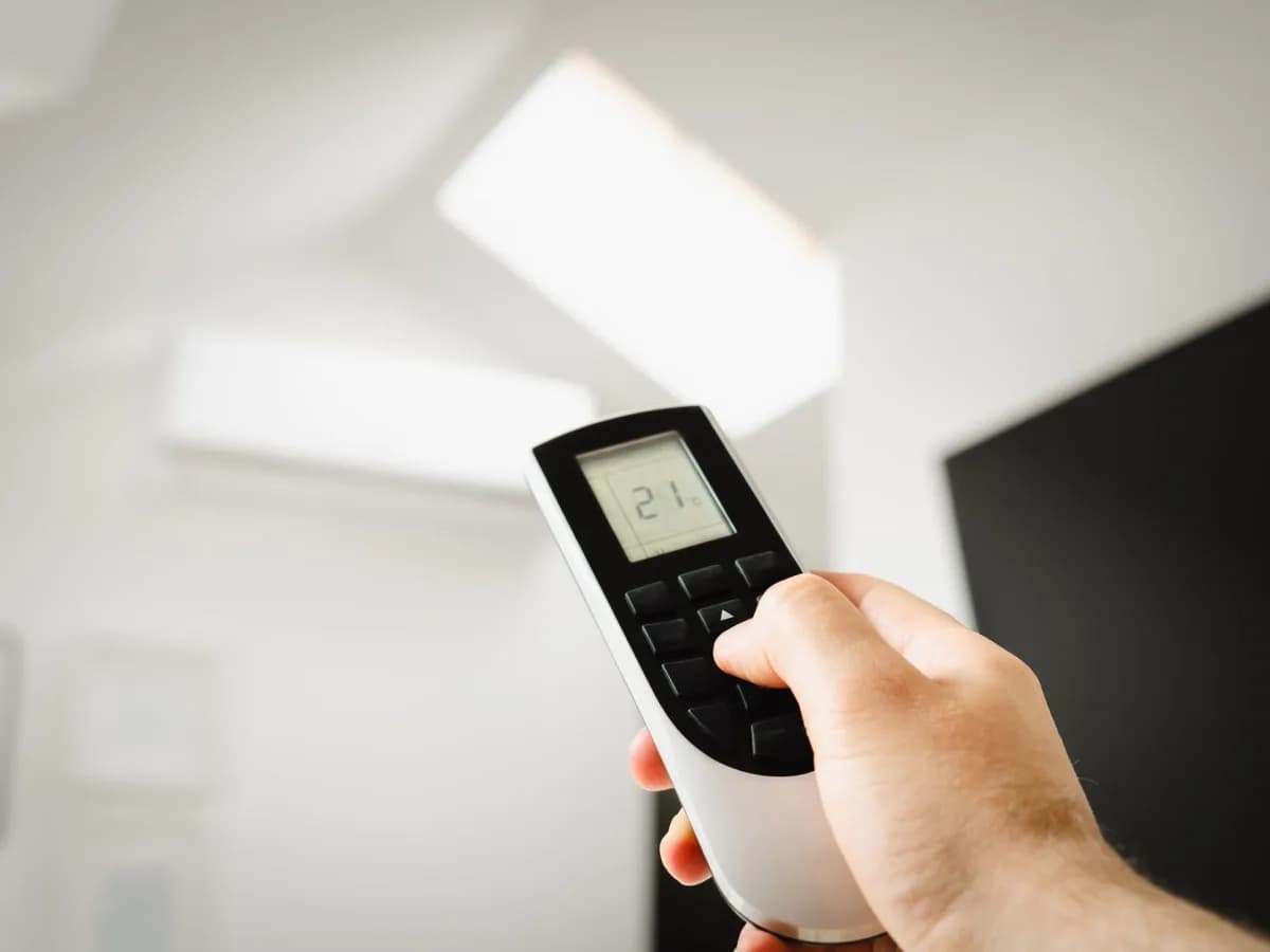 HVAC technician working on thermostat
