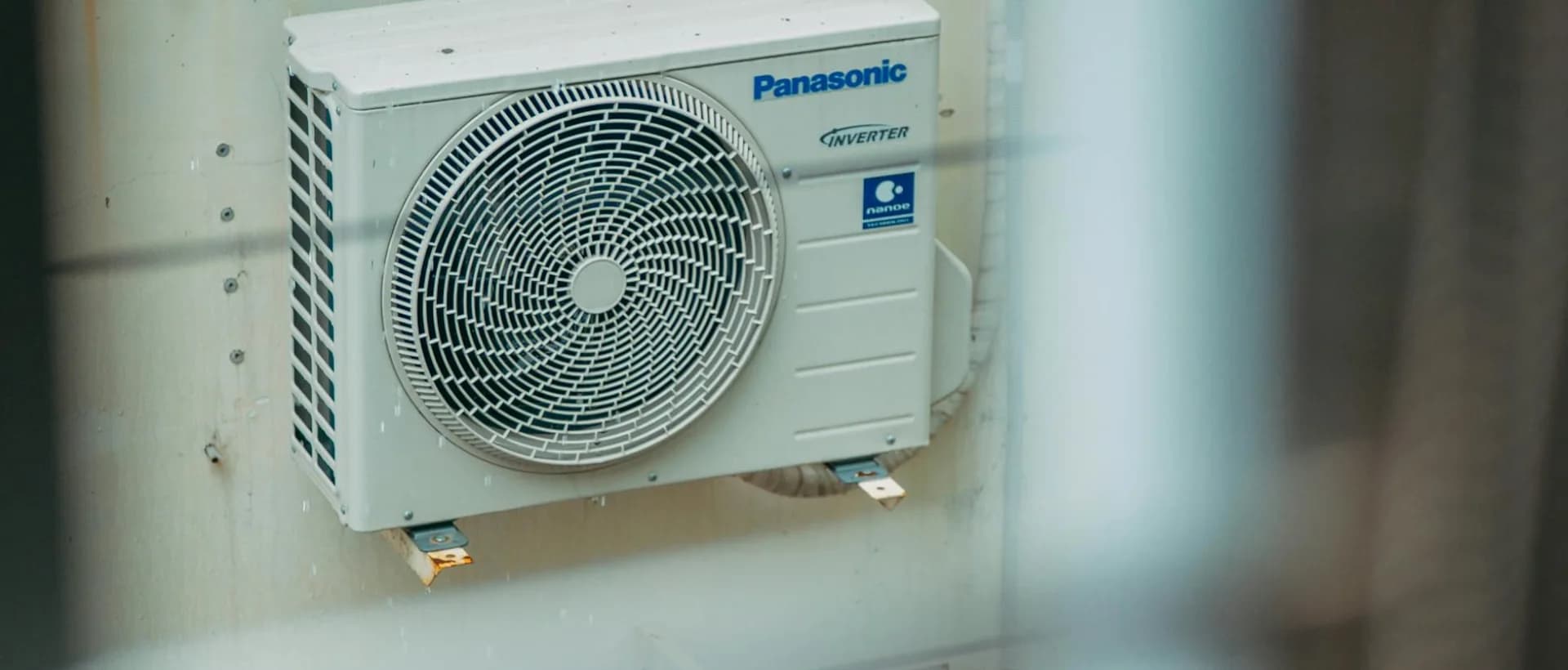 Technician inspecting air conditioning unit in Toronto home