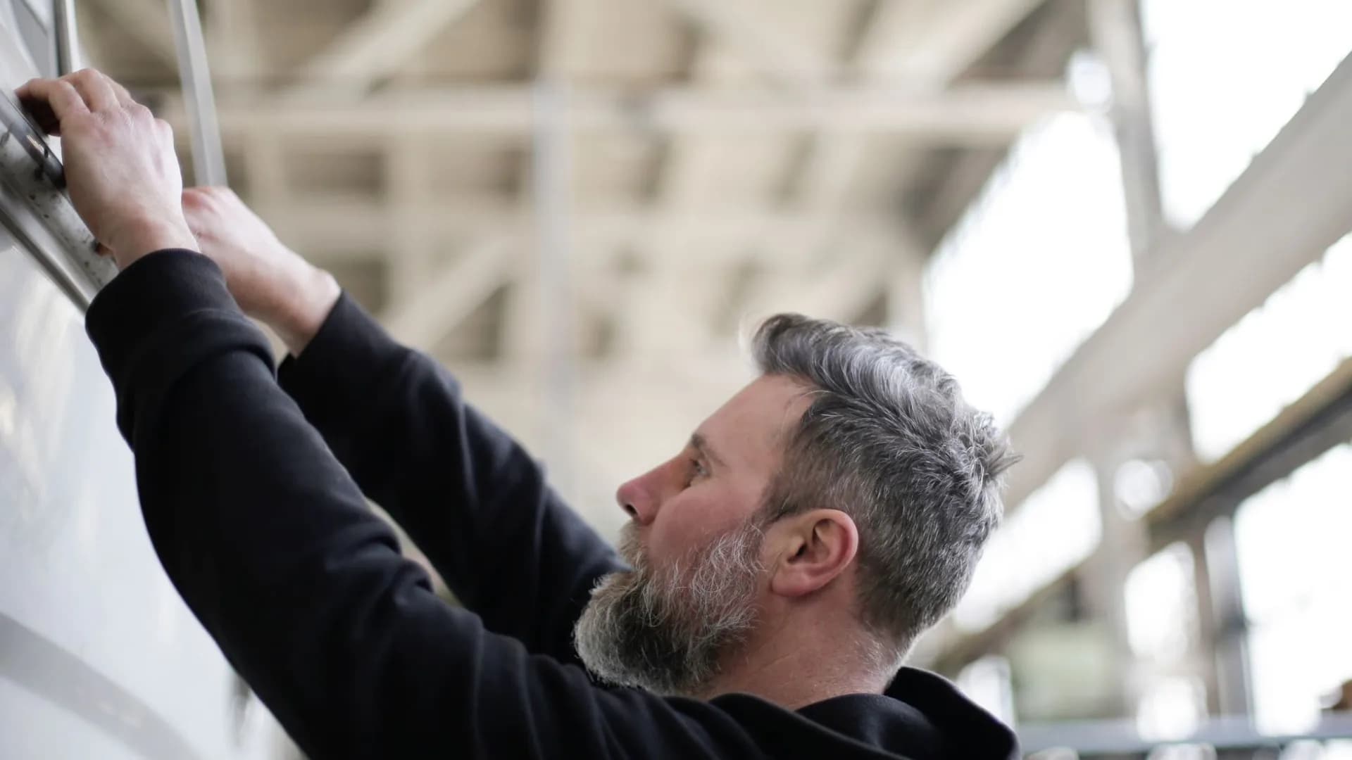 Technician inspecting dusty ductwork in a home