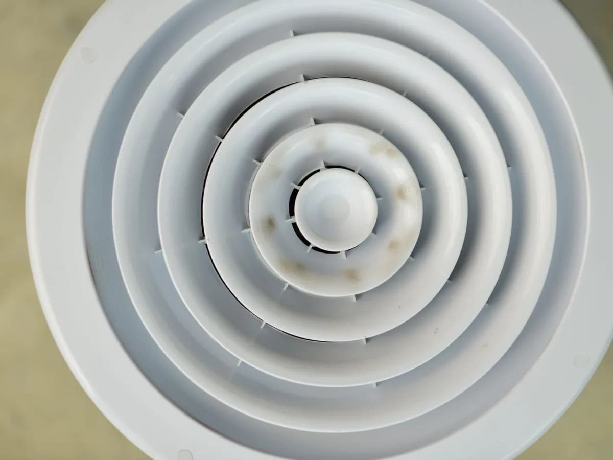 Technician installing bathroom fan