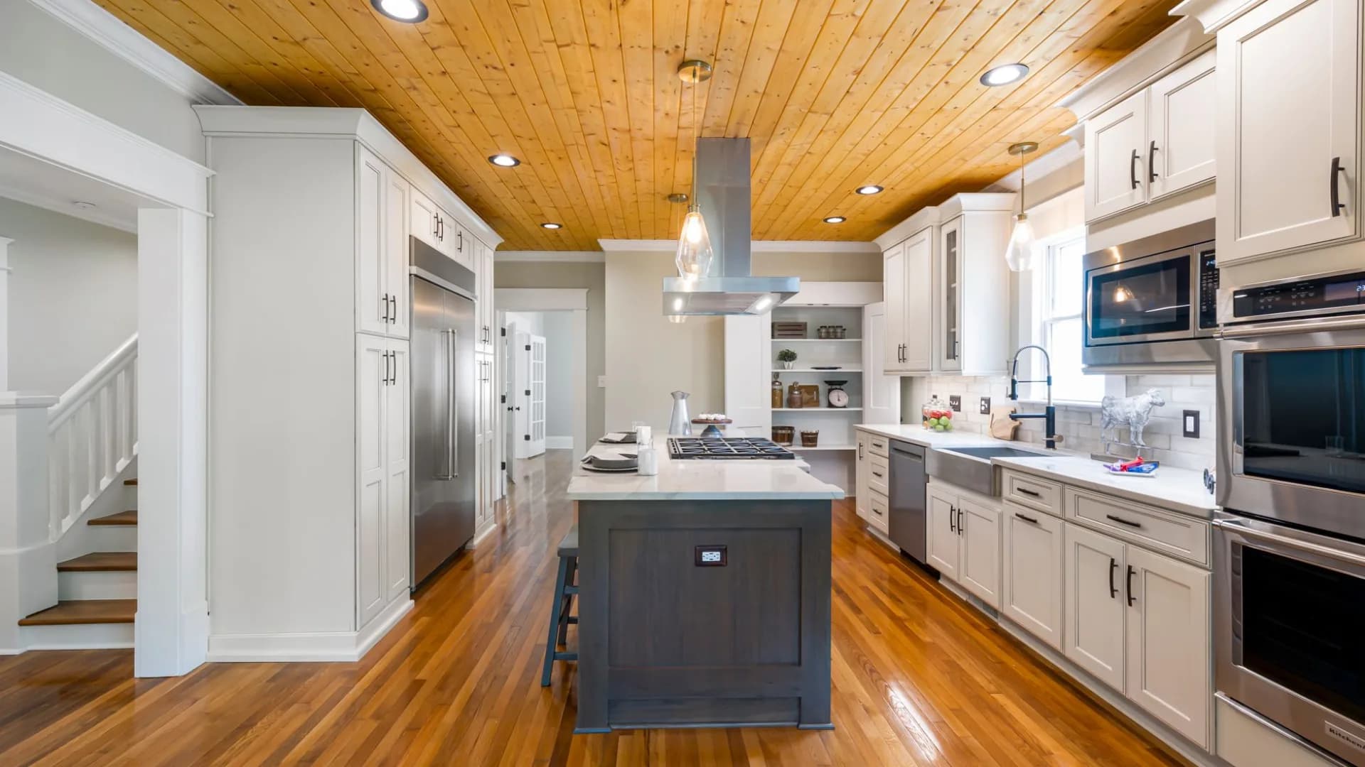 Person installing a modern range hood in kitchen