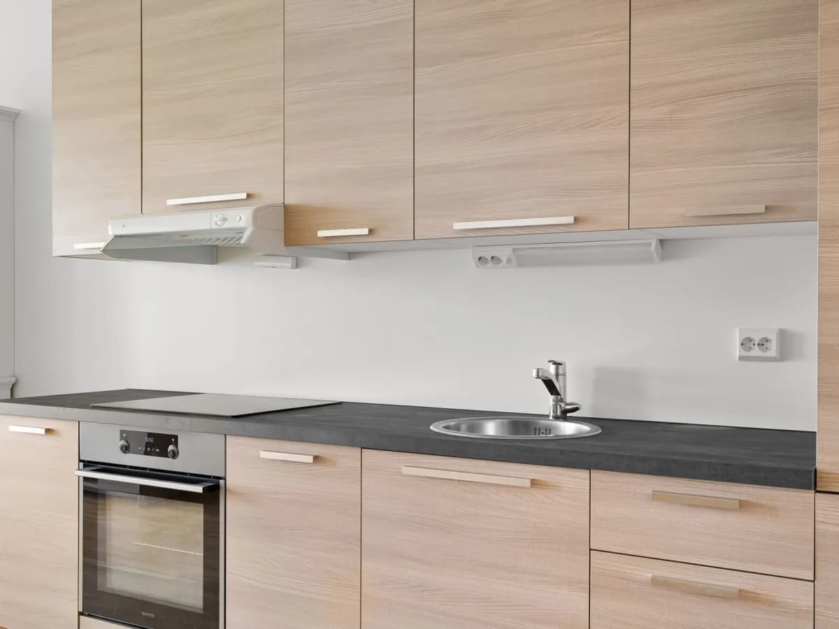 Removing an old range hood from the kitchen