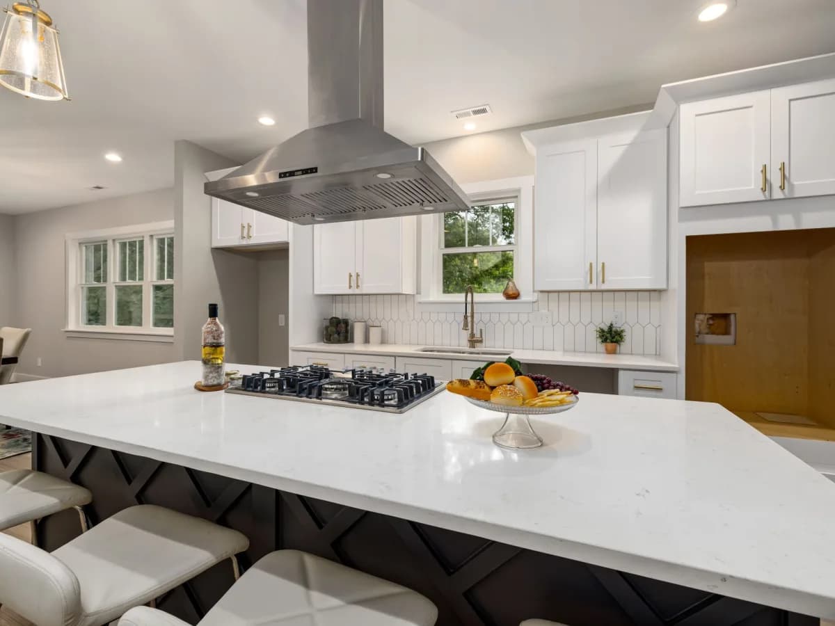 Finished kitchen showcasing an installed range hood above the stove