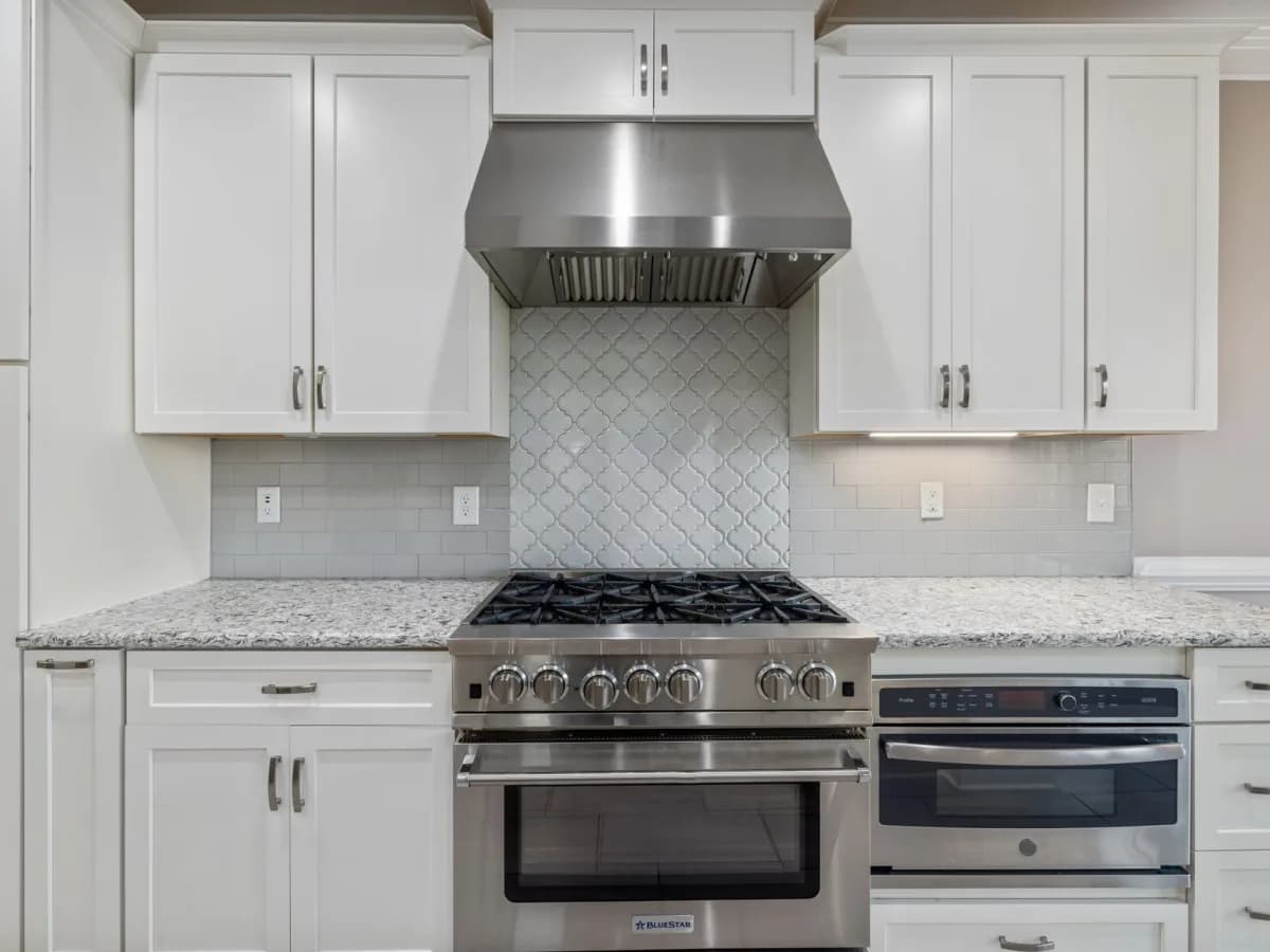 Close up of range hood installation under cabinets