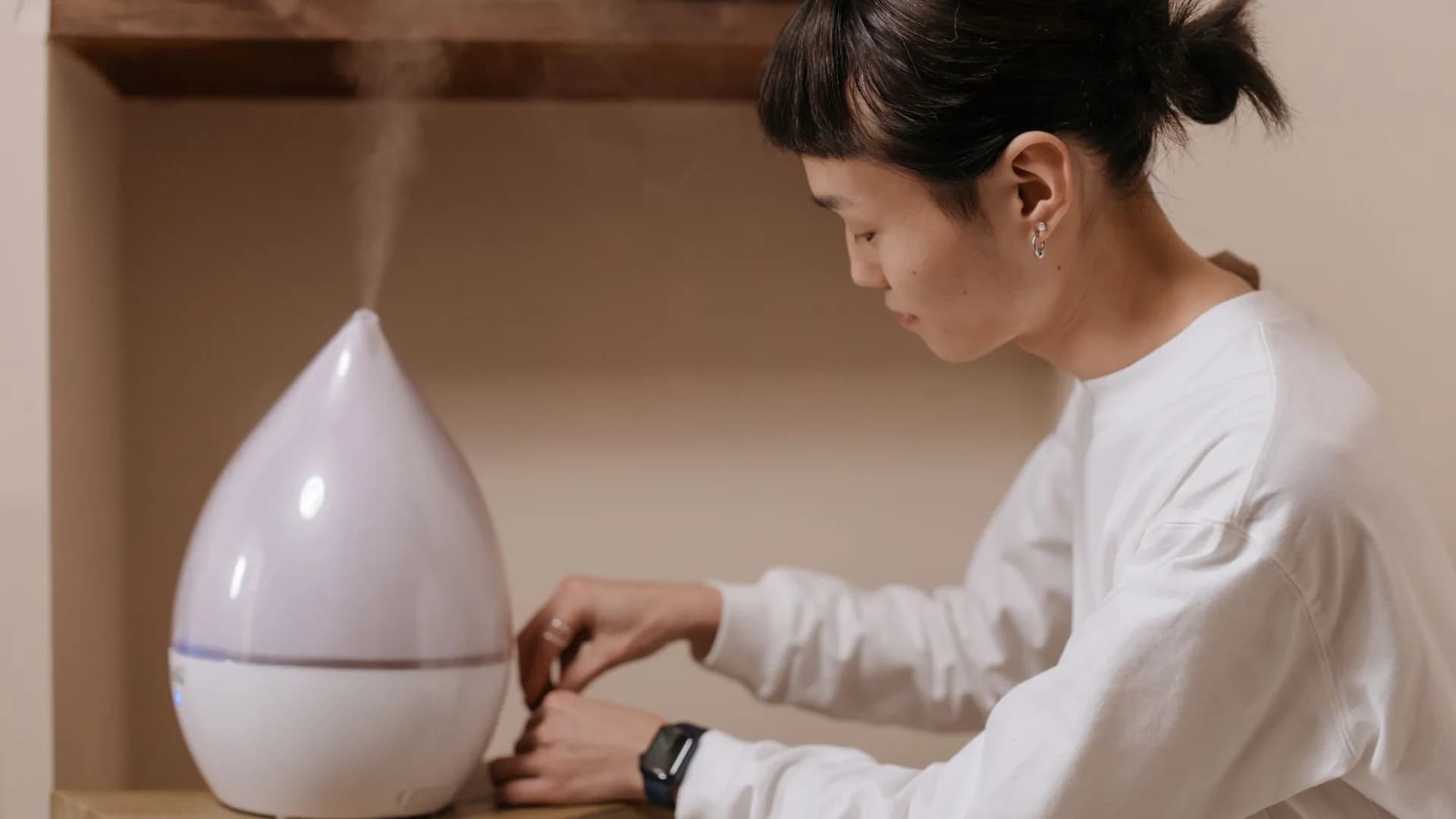 Person inspecting a humidifier at home