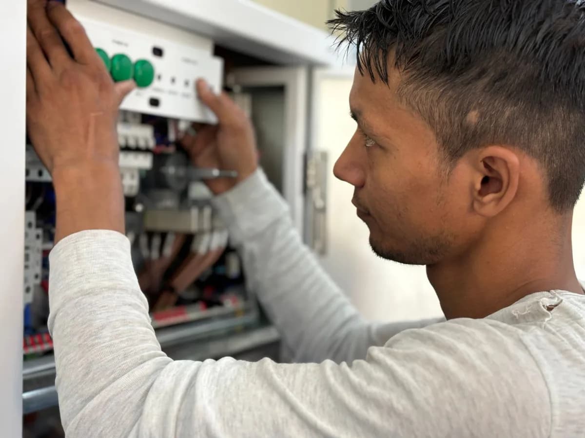 Technician connecting the new humidifier to the furnace