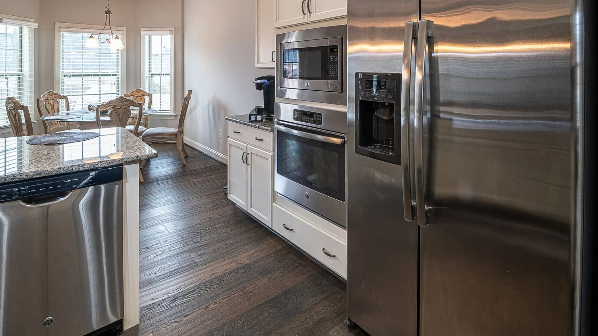 Technician installing a new dishwasher in a modern kitchen