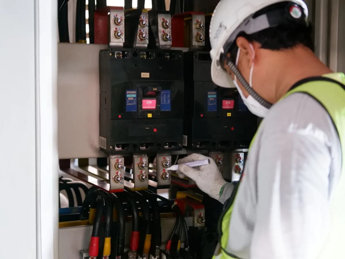 Technician connecting electrical wires to an oven