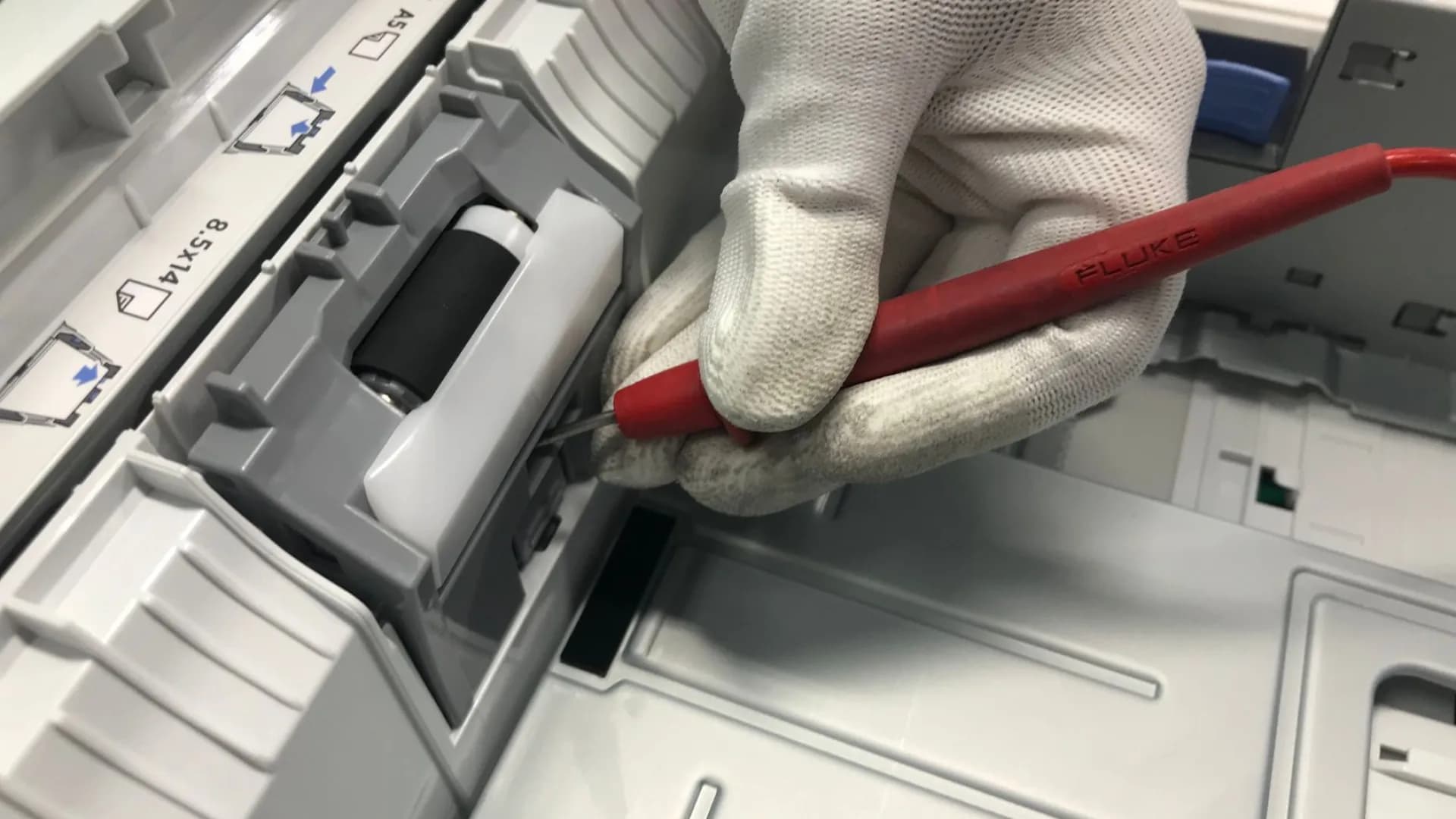Technician repairing washing machine in laundry room