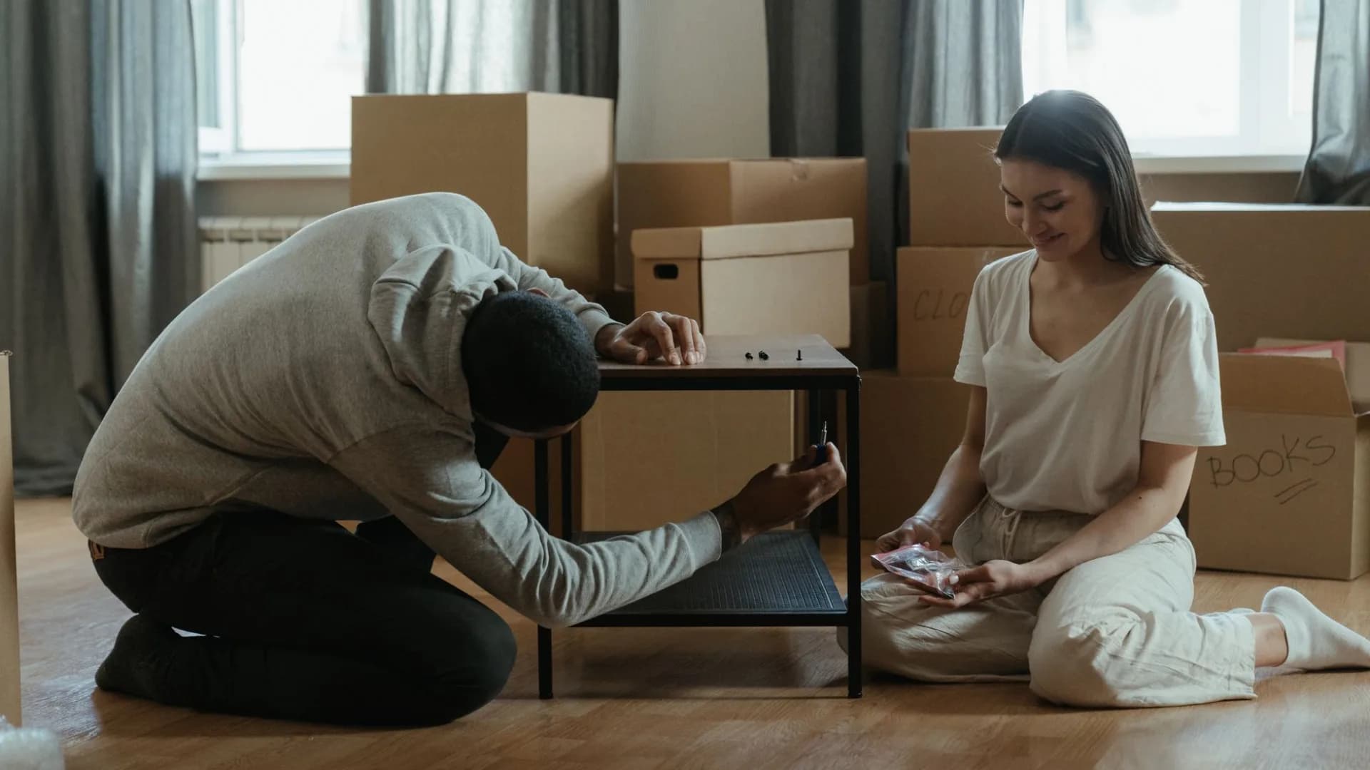 Professional assembling bed frame in a bright living room