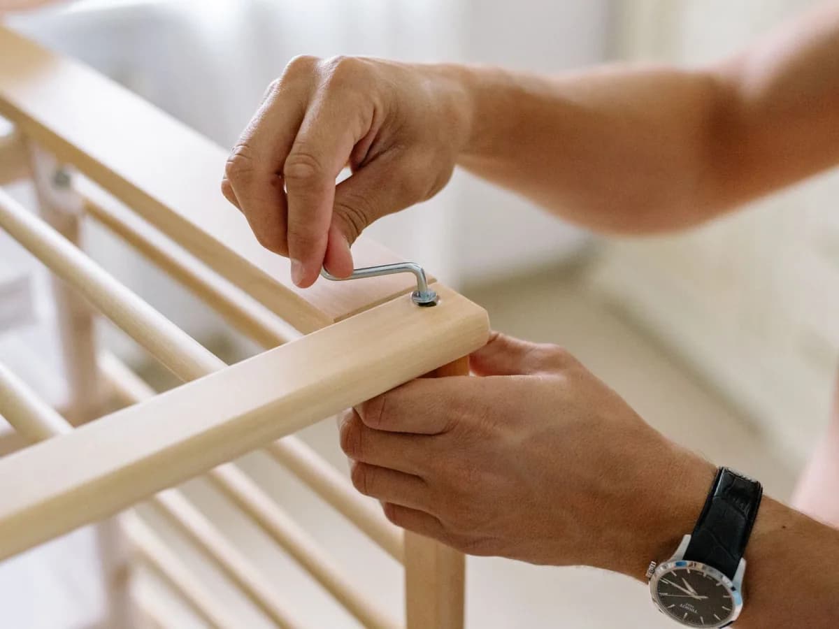 Professional assembling a wardrobe in a residential space