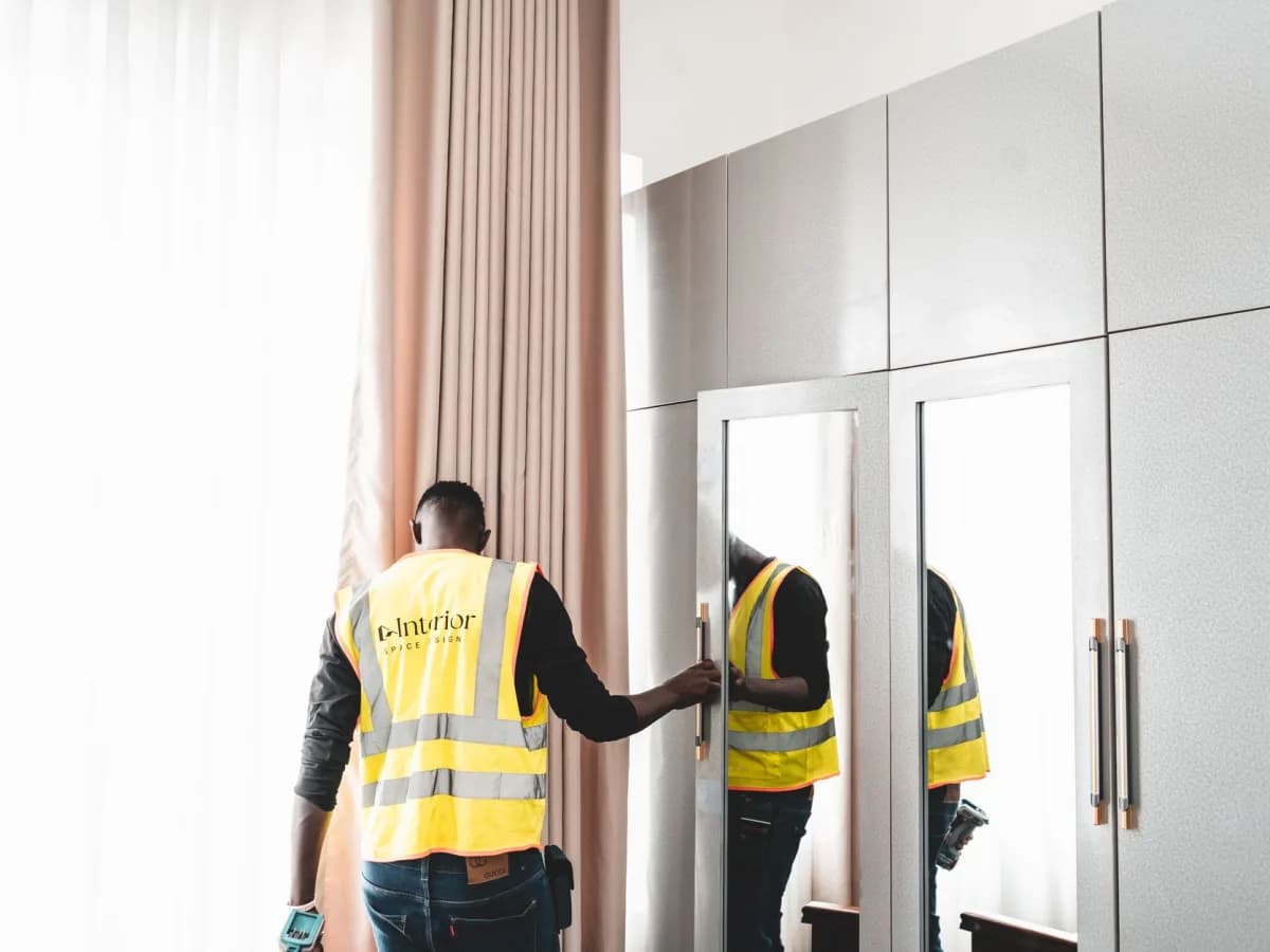 Professional aligning a large mirror for mounting