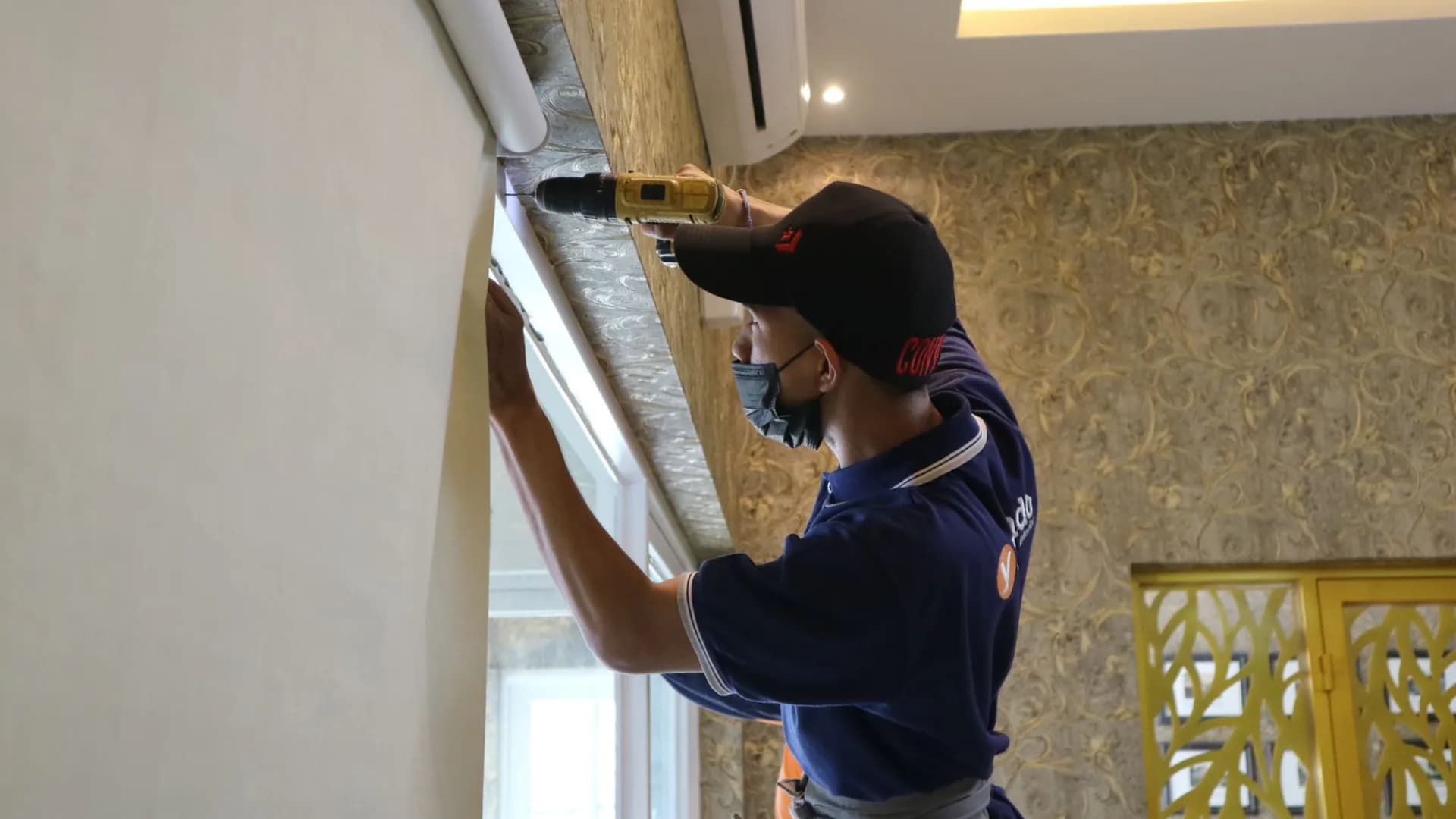 Technician installing security cameras on a house