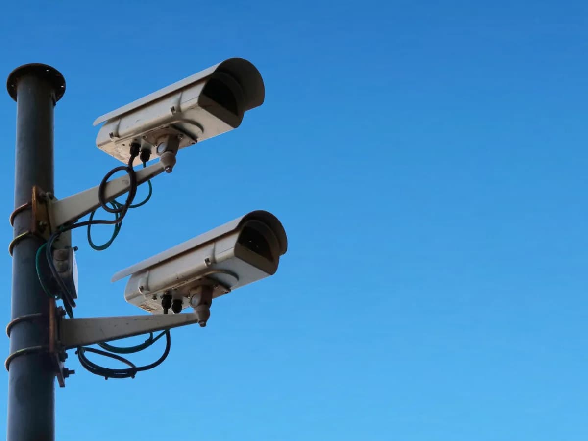 A technician setting up security cameras