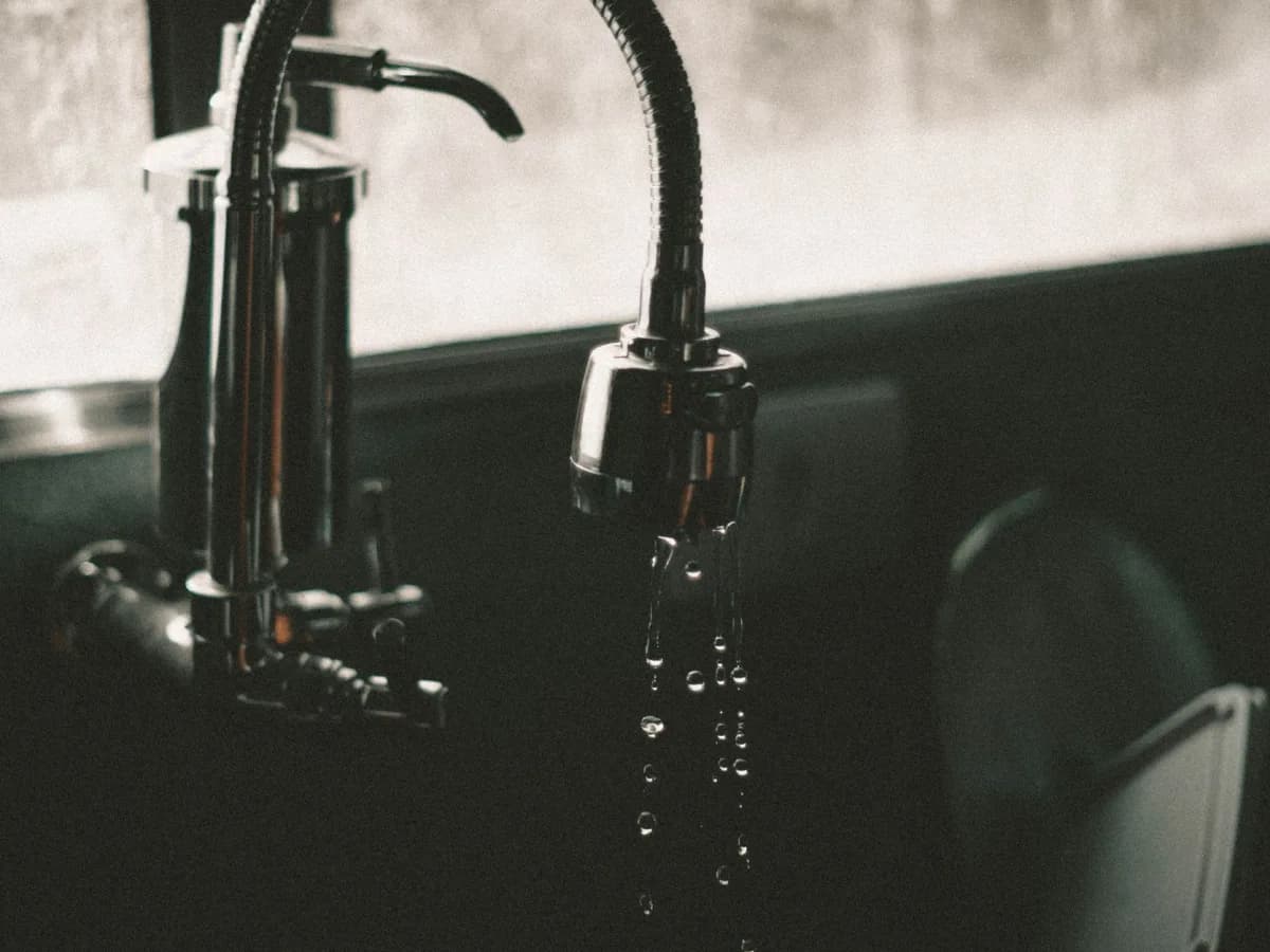 Close-up of a leaky kitchen faucet