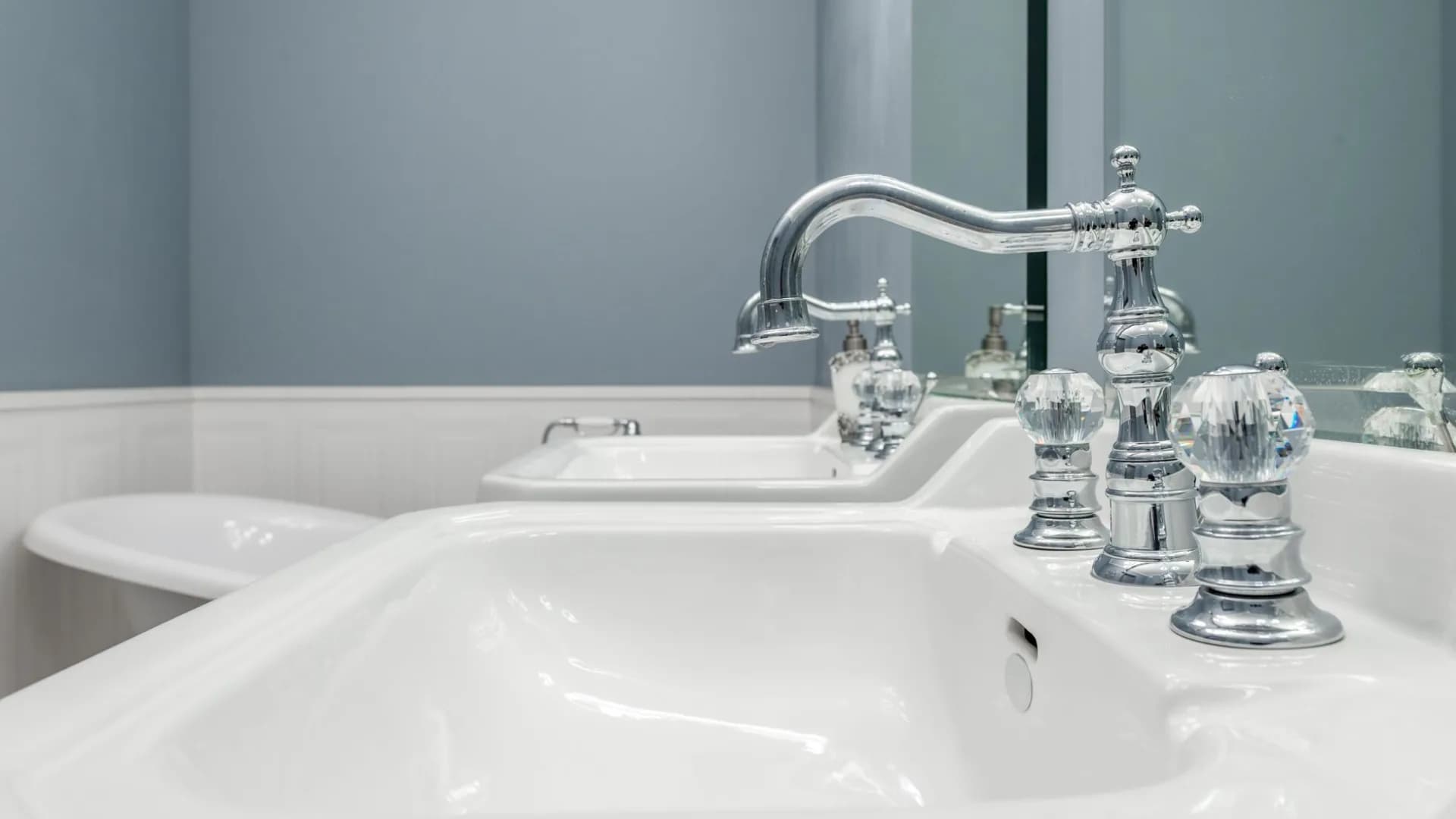 Modern bathroom with sink and faucet needing repairs