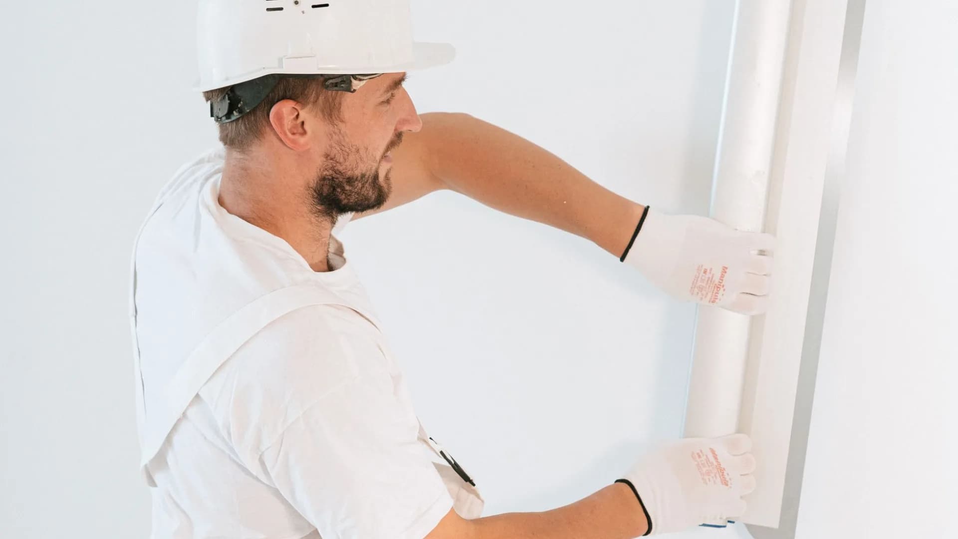 Professional repairing a leaky sink in a condo bathroom