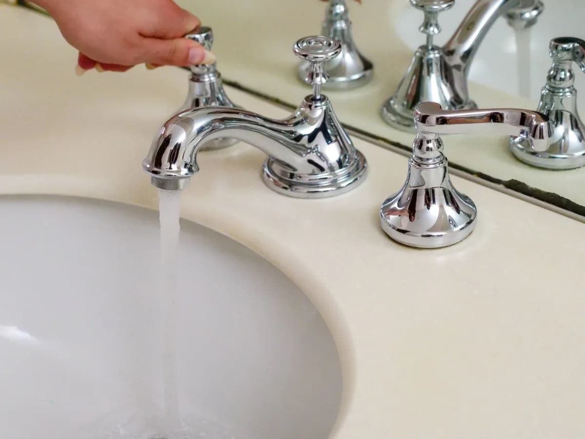 Tightening a sink fixture in a bathroom