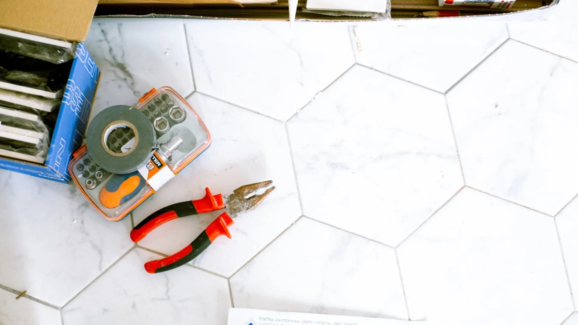 Bathroom being repaired by a professional with tools around.