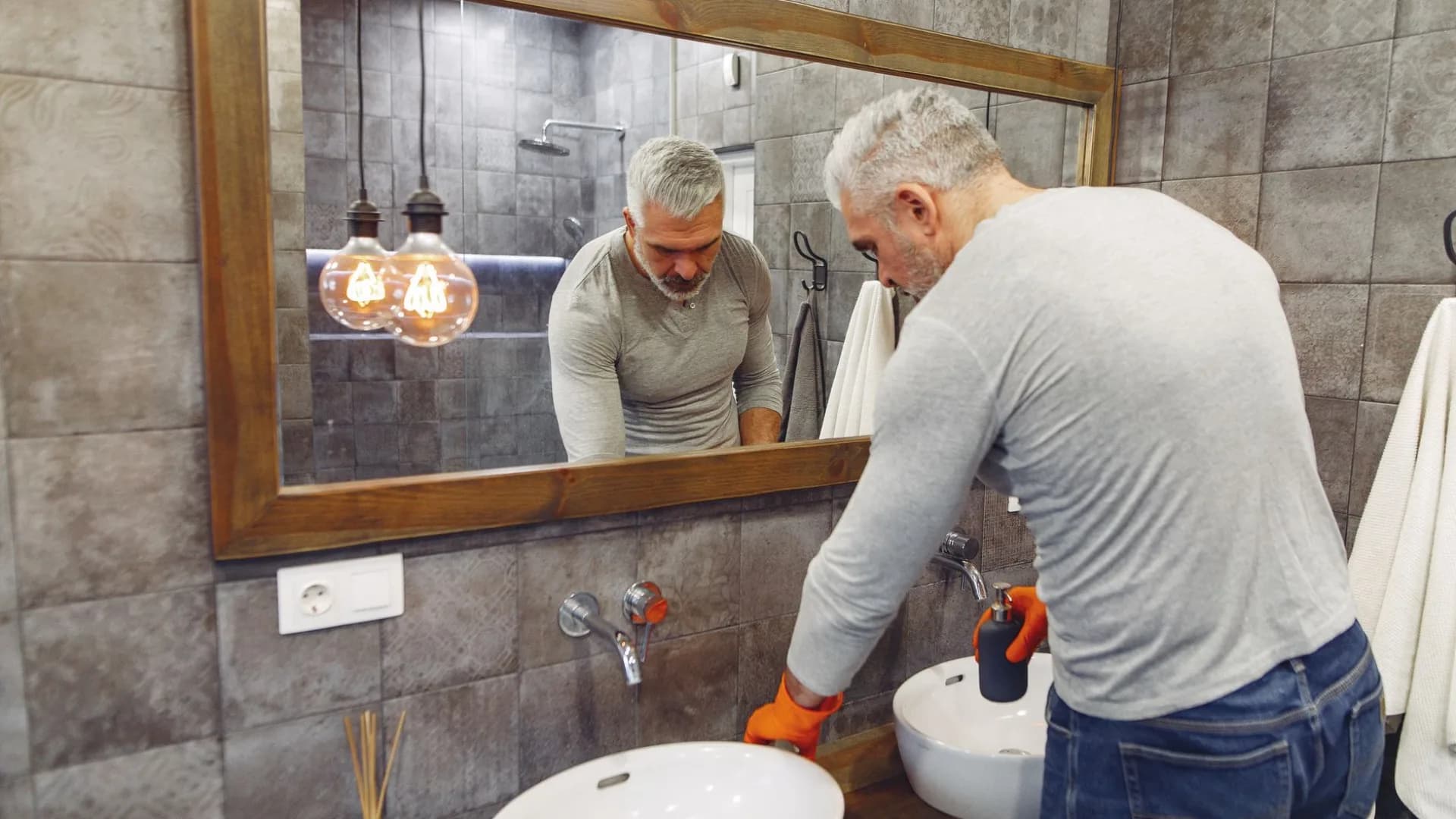 Contractor repairing a bathroom sink in Toronto
