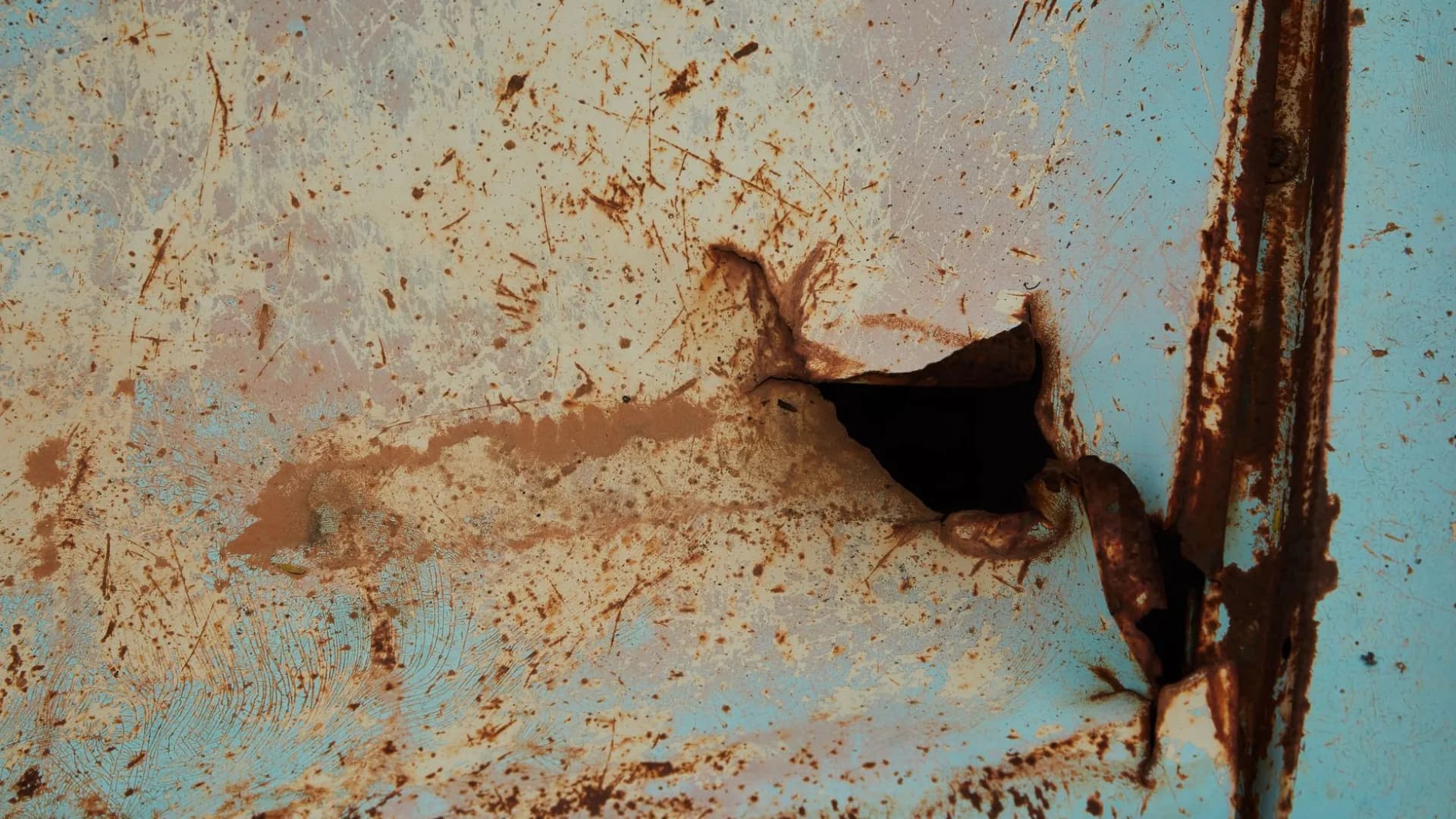 Close-up of worn caulking in a bathtub with visible damage.