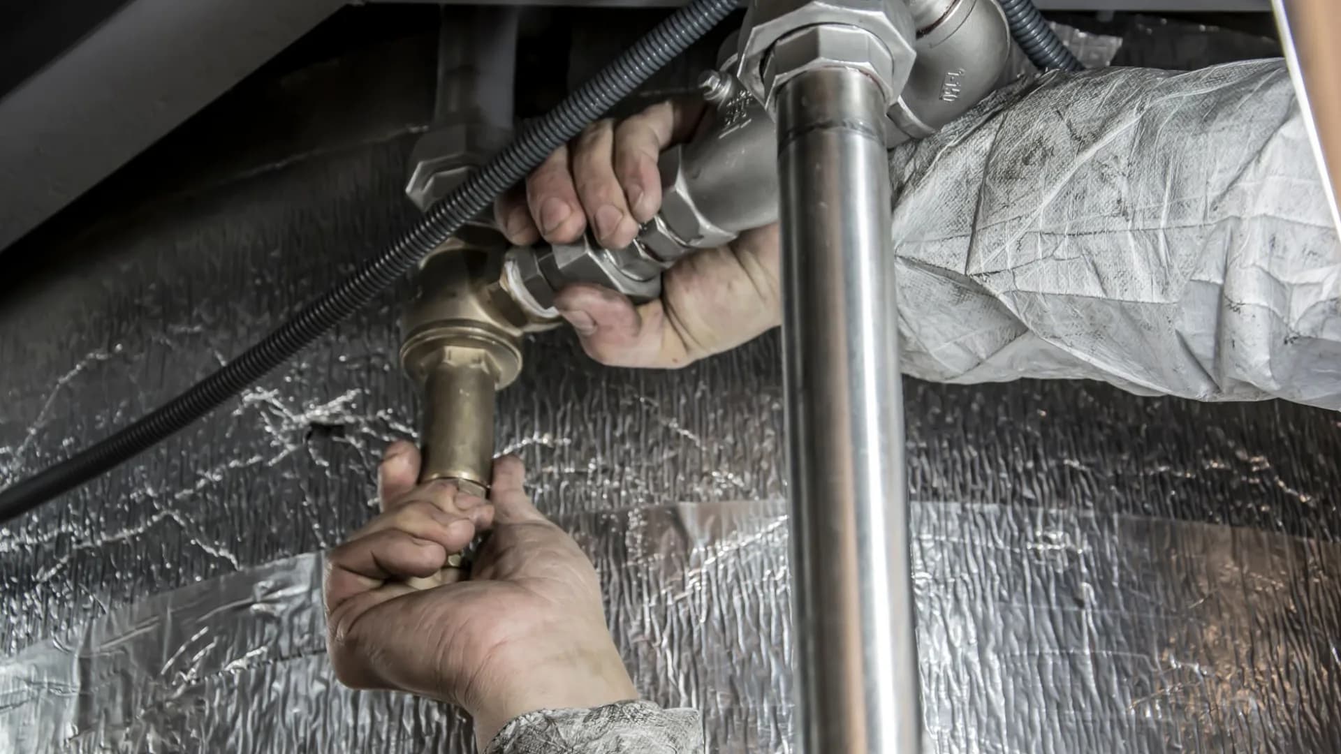 Homeowner inspecting sink plumbing