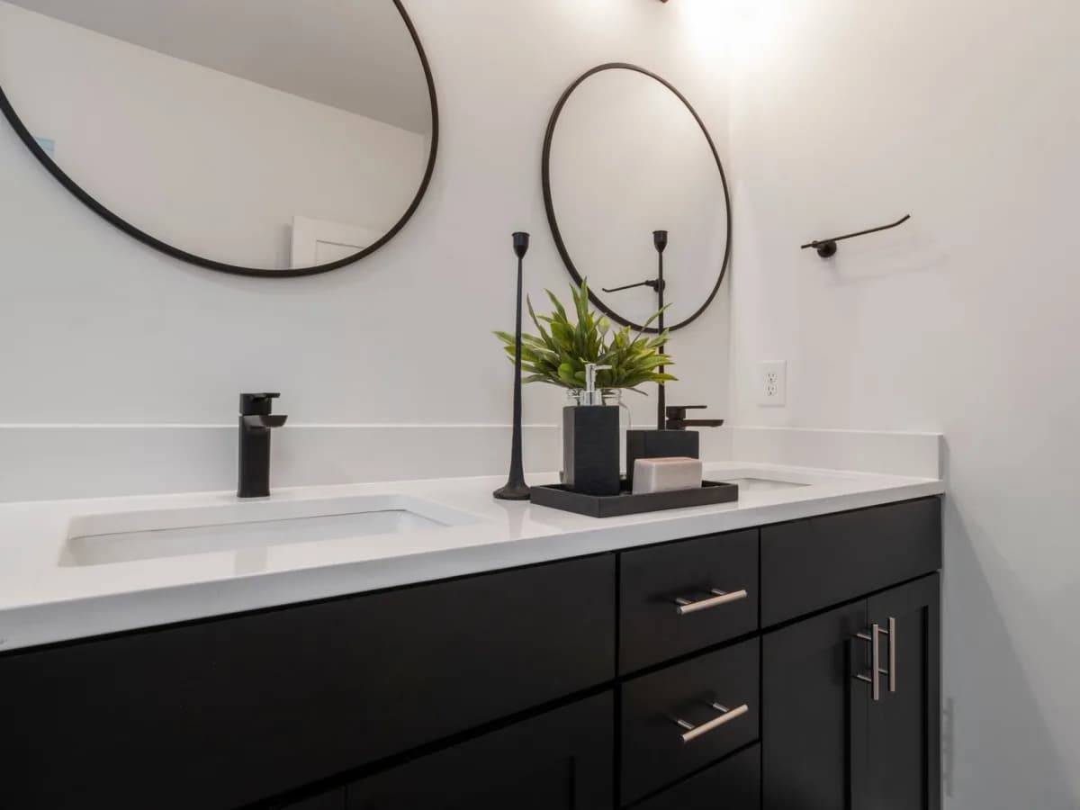 Completed bathroom vanity with sink, faucet, and finished wall details.