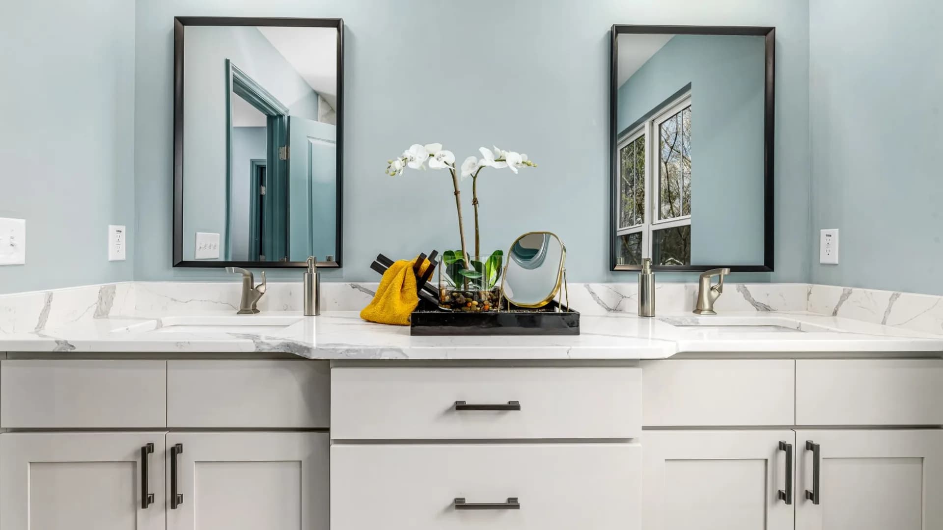 Installer leveling a new bathroom vanity in a residential bathroom.