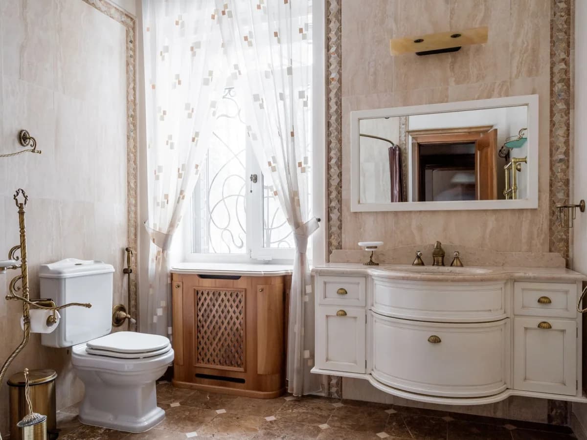 Bathroom plumbing exposed after an old vanity has been removed.