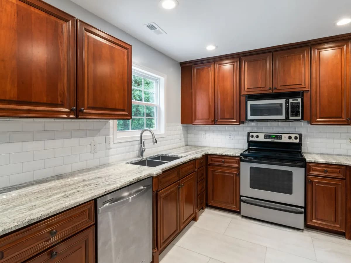 Tile samples, grout options, trim, and layout tools on a kitchen counter.
