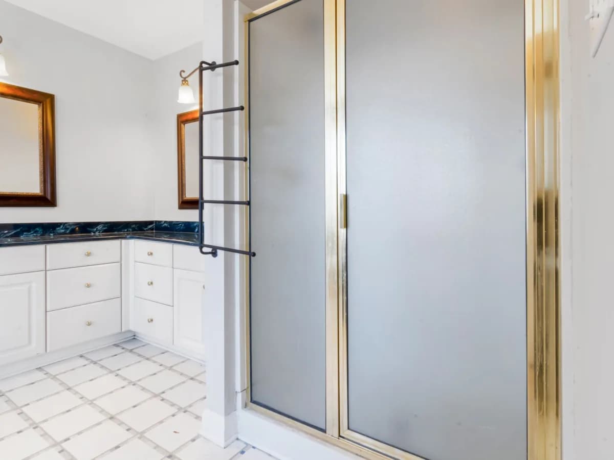 Comparison of damaged and new glass shower door.
