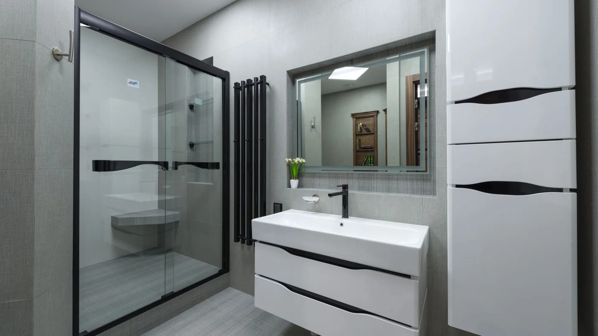 Mom inspecting a faulty shower door in a bright bathroom