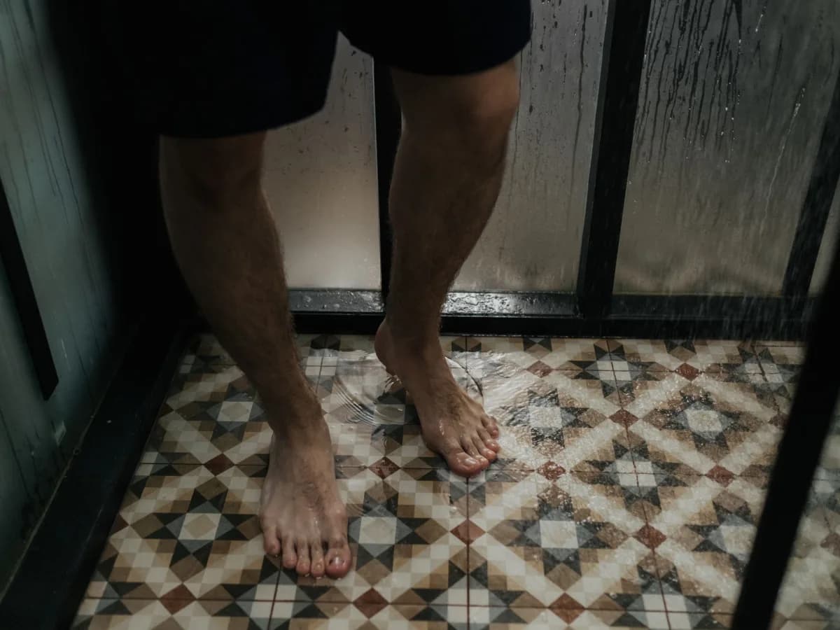 Soaked bathroom floor from shower door leak